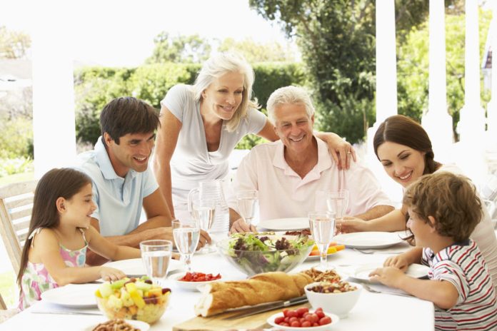 42396968 - family eating lunch outside in garden